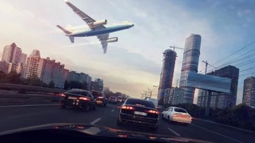 An image of a car driving under a flying airplane